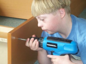 A boy using an electric drill